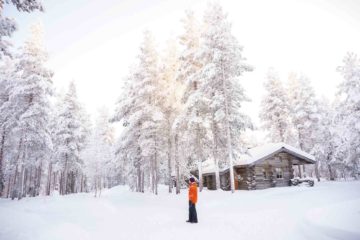 A man looks out at a snowy landscape in Swedish Lapland, Sweden