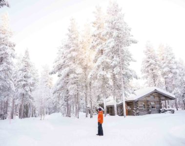 A man looks out at a snowy landscape in Swedish Lapland, Sweden