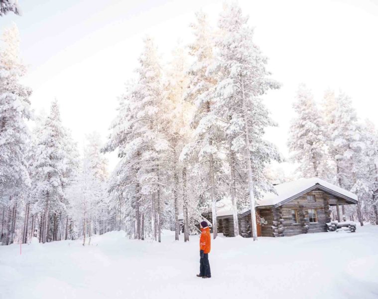 A man looks out at a snowy landscape in Swedish Lapland, Sweden