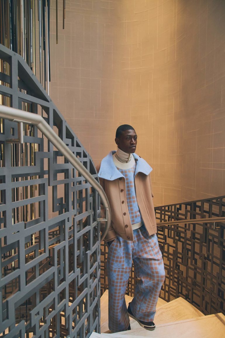 Jacket, sweater, trousers and high-neck shirt, Wan Hung; shoes, toP owens Collection. location: Four seasons new York Downtown.