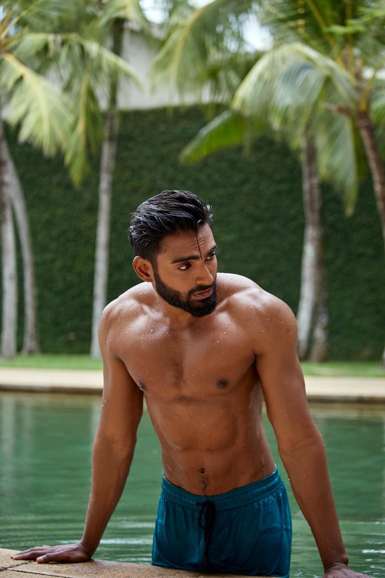 Model wearing turquoise recycled polyester swim shorts by Vilebrequin at Amangalla, an Aman resort, Galle, Sri Lanka