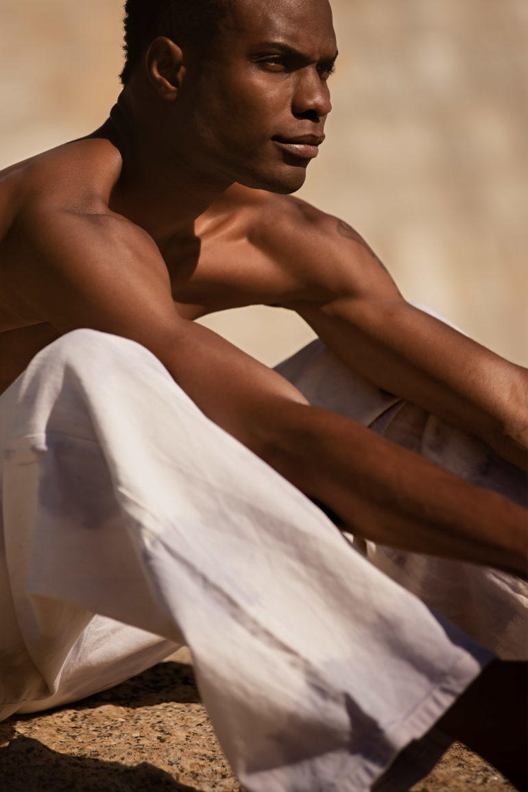 Model wearing tie-dye lavender stripe painter pants by Ullac Oy in Bantry Bay, Cape Town, South Africa