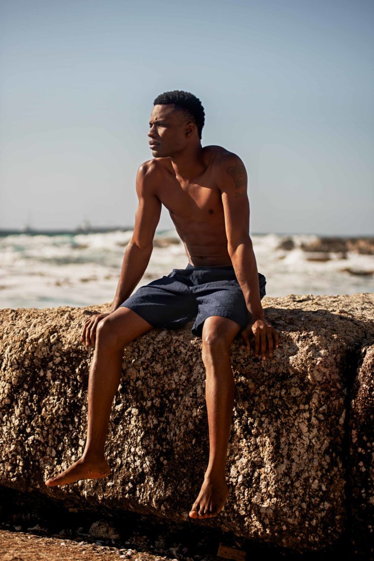 Model wearing navy seersucker 'PJ' shorts by Brooks Brothers in Bantry Bay, Cape Town, South Africa
