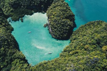 Boats cruising around a cove in Thailand