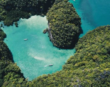 Boats cruising around a cove in Thailand