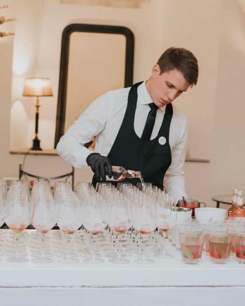 A waiter serves drinks at Antiq Palace and Spa, Ljubljana, Slovenia