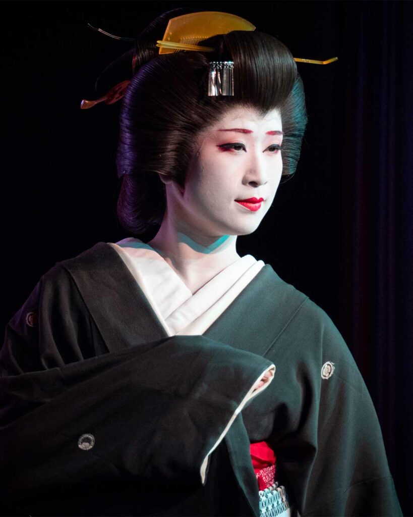 A geisha poses for a photograph in Tokyo, Japan