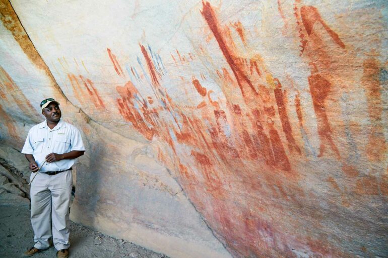 Guide explaining cave paintings near Bushmans Kloof, Western Cape, South Africa