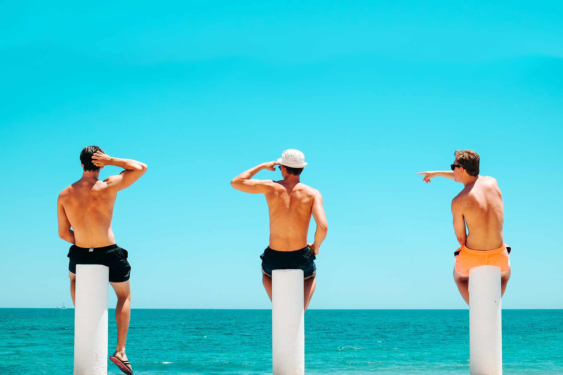 Three guys on beach for the Travel & Adventure Show