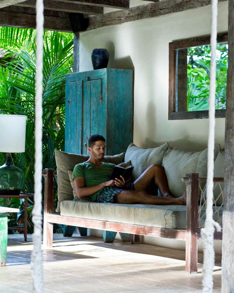 Model reads at Uxua Casa Hotel, Trancoso, Brazil
