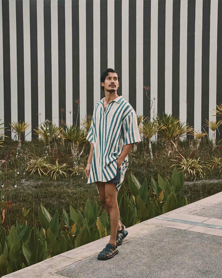 Model wears oversized shirt, Phuket, Thailand