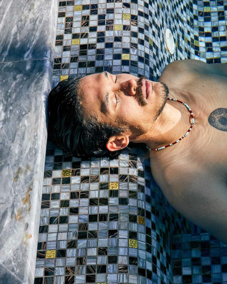 Model relaxes in pool, Phuket, Thailand