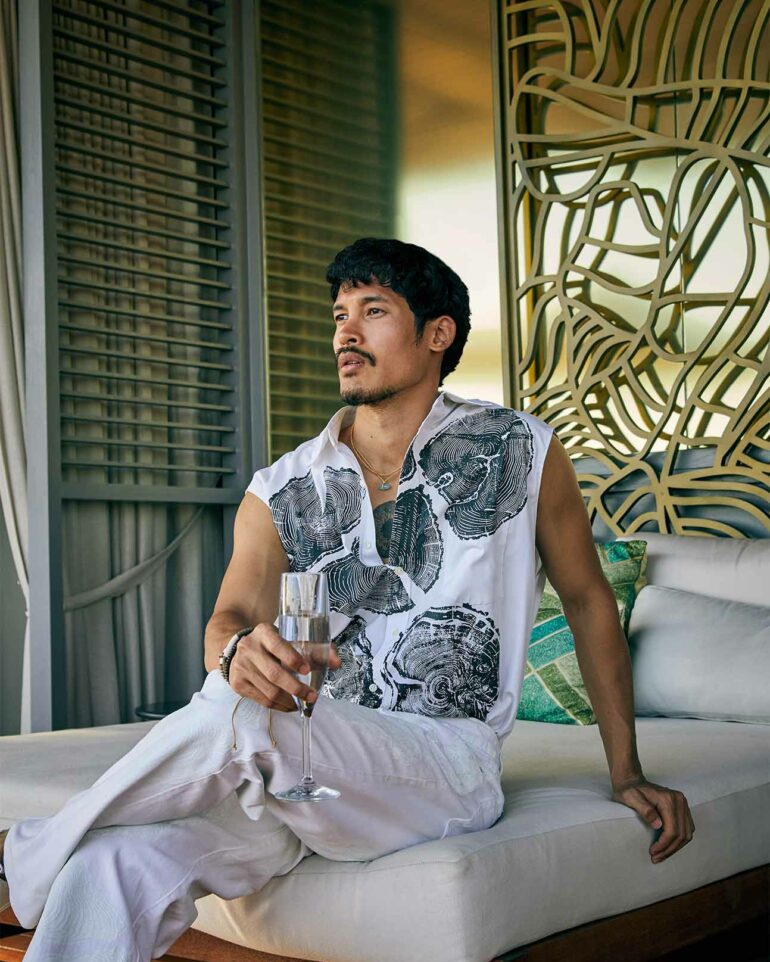 Model relaxes on their bed in Phuket, Thailand