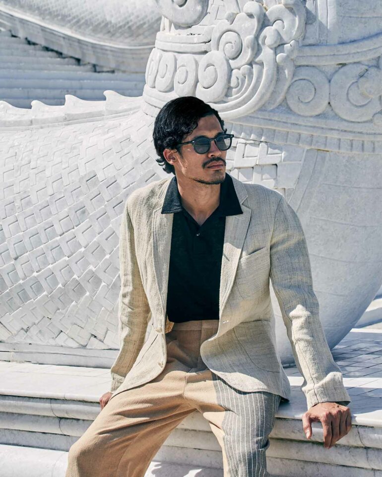 Model wears a beige suit in Phuket, Thailand