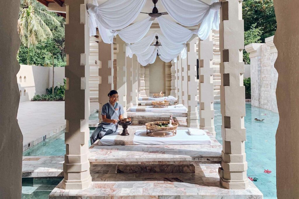 A massage therapist prepares a treatment at a Thai spa