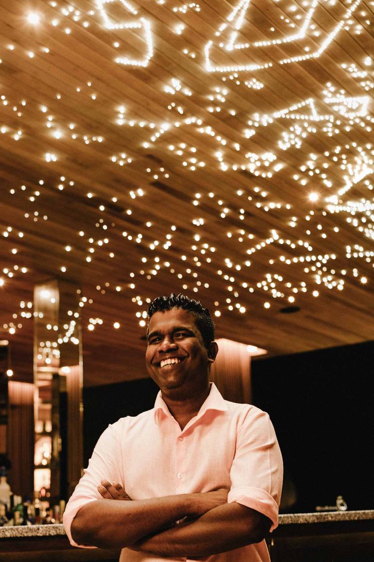 A sky guru standing beneath an installation of the constellations at Anantara Kihava Maldives Villas, The Maldives