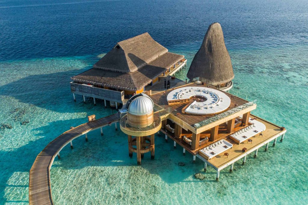 Aerial of the overwater observatory and adjoining dining area at Anantara Kihava Maldives Villas, The Maldives