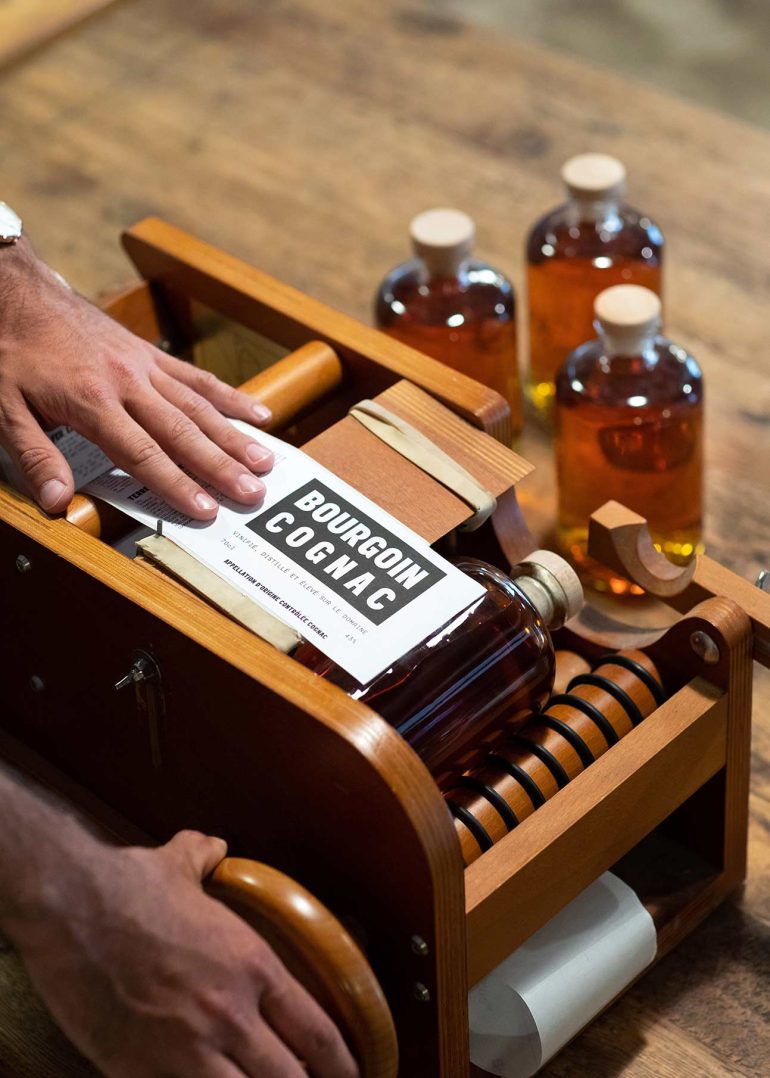 Bourgoin Cognac bottle being labelled in Charente, France