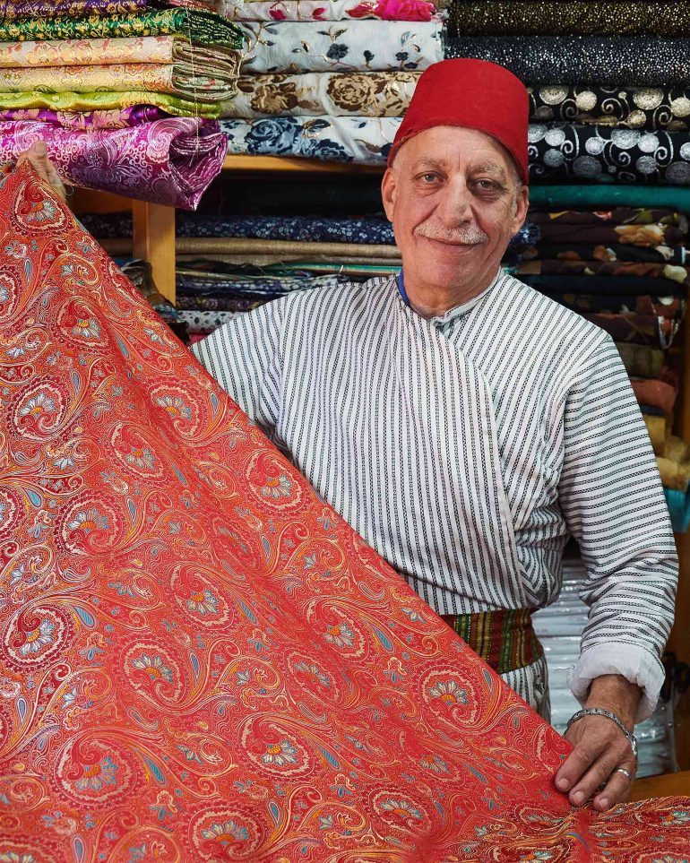 Fabrics merchant Bilal Abu Khalaf in his shop in Jerusalem, Israel