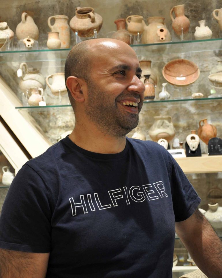 Antiquities trader Zak Mishriky in his shop in Jerusalem, Israel
