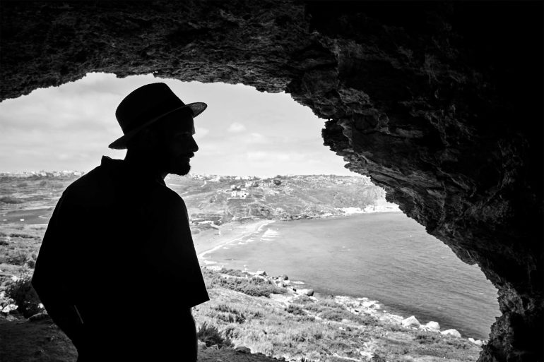 Model looks out over Xlendi in Gozo, Malta