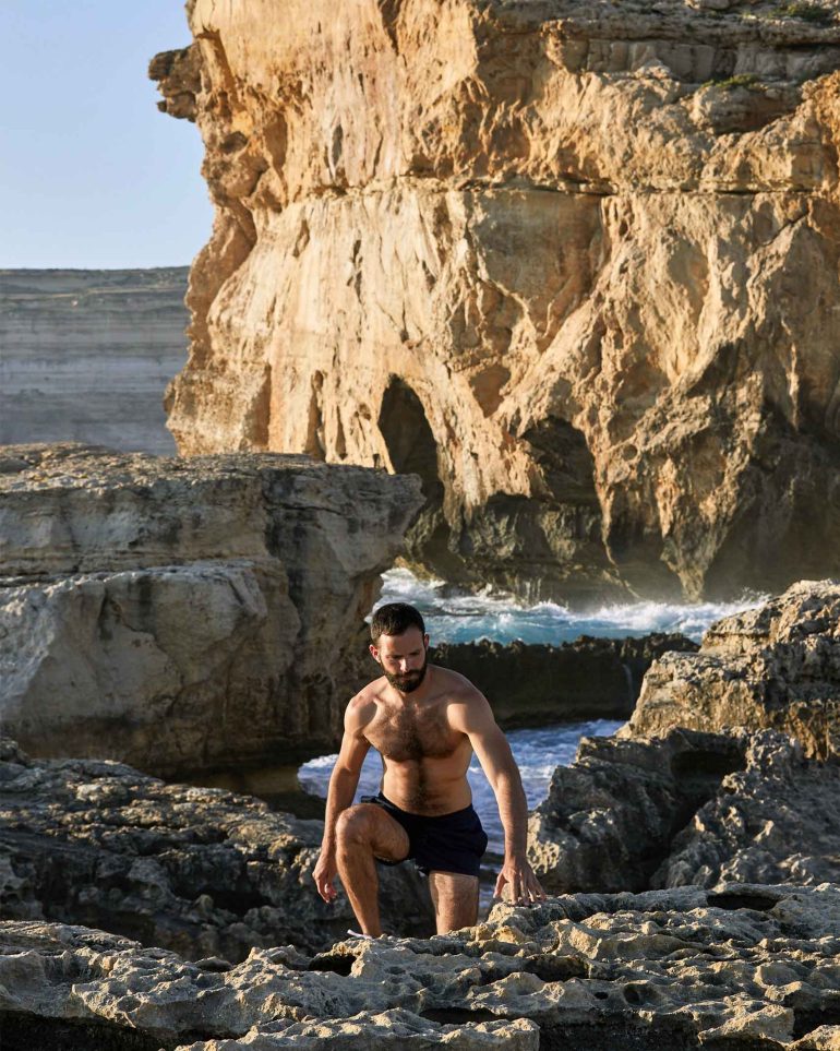 Model emerges from the sea. in Comino, Malta