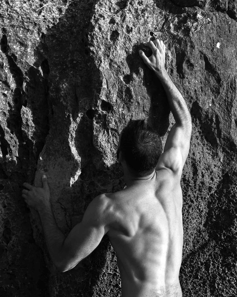 Model scales the rocks of Comino, Malta