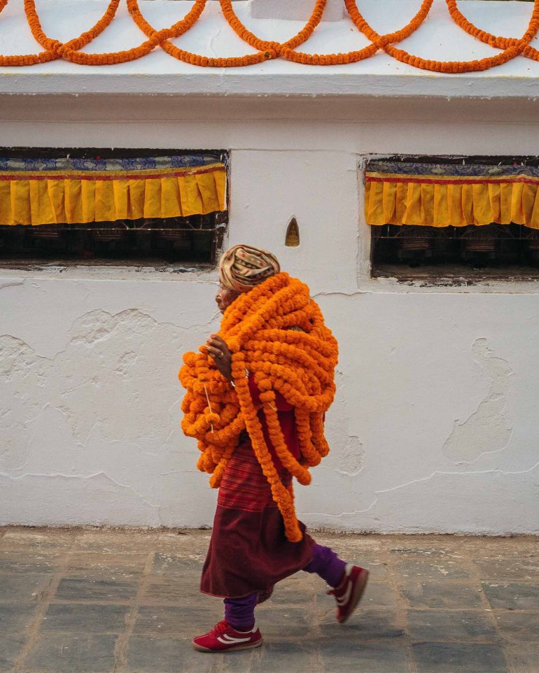 A man carrying marigold garlands in Kathmandu, Nepal