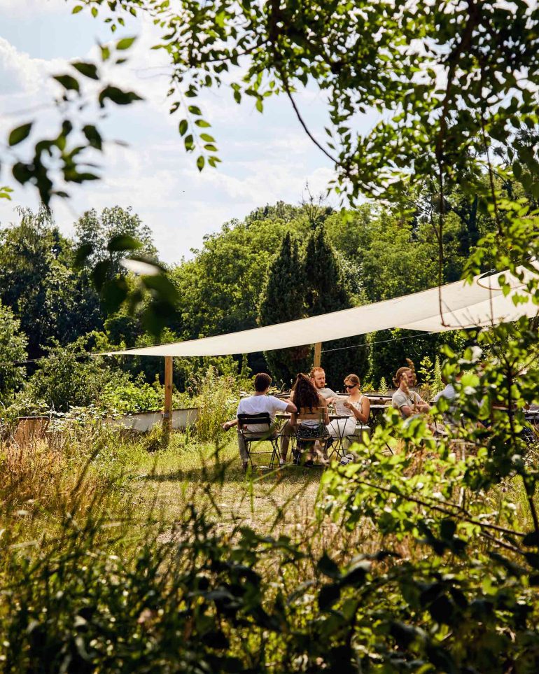 Guests enjoy an outdoor lunch at Hof Flieht, Uckermark, Germany