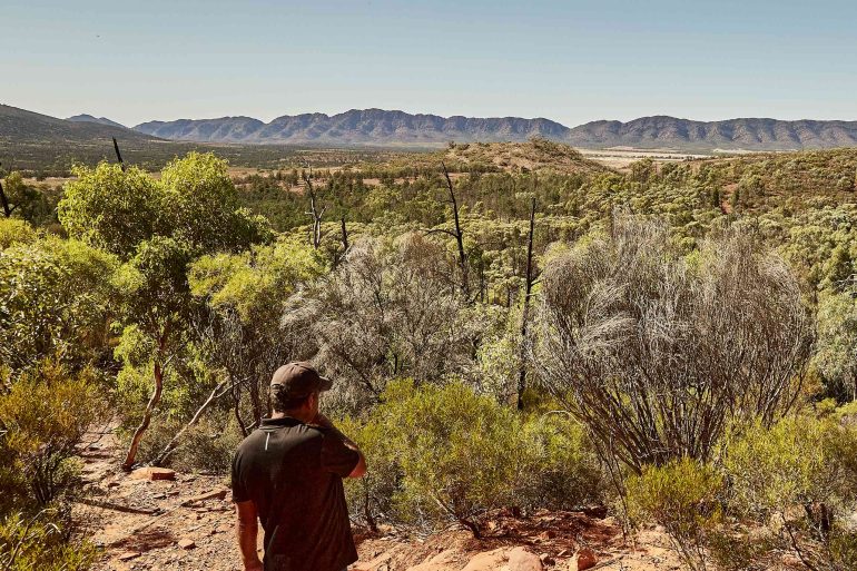 A local man looks out over a vast landscape in South Australia, Australia