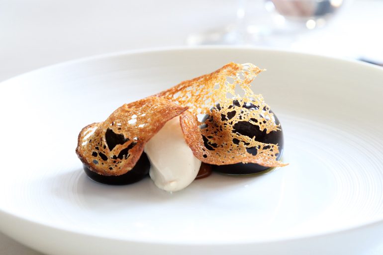 A carefully presented dessert with a scoop of gelato