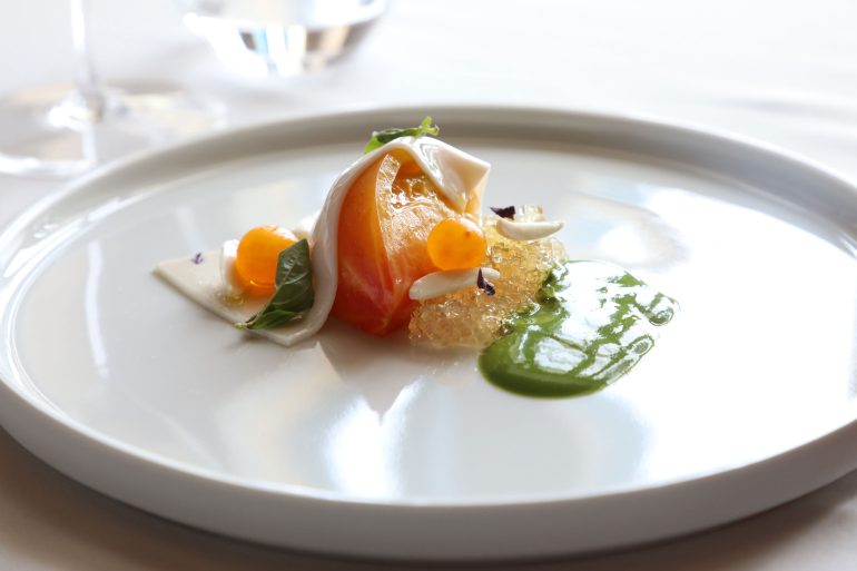 A beautifully presented appetiser on a white plate