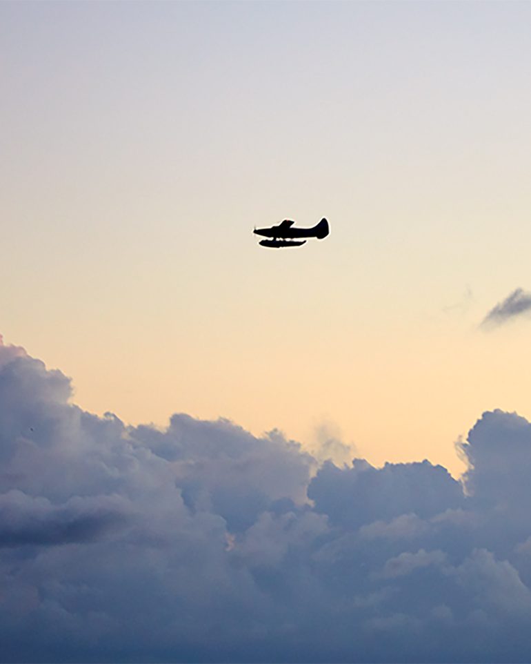 A seaplane descends during sunset in The Florida Keys and Key West, Florida, USA