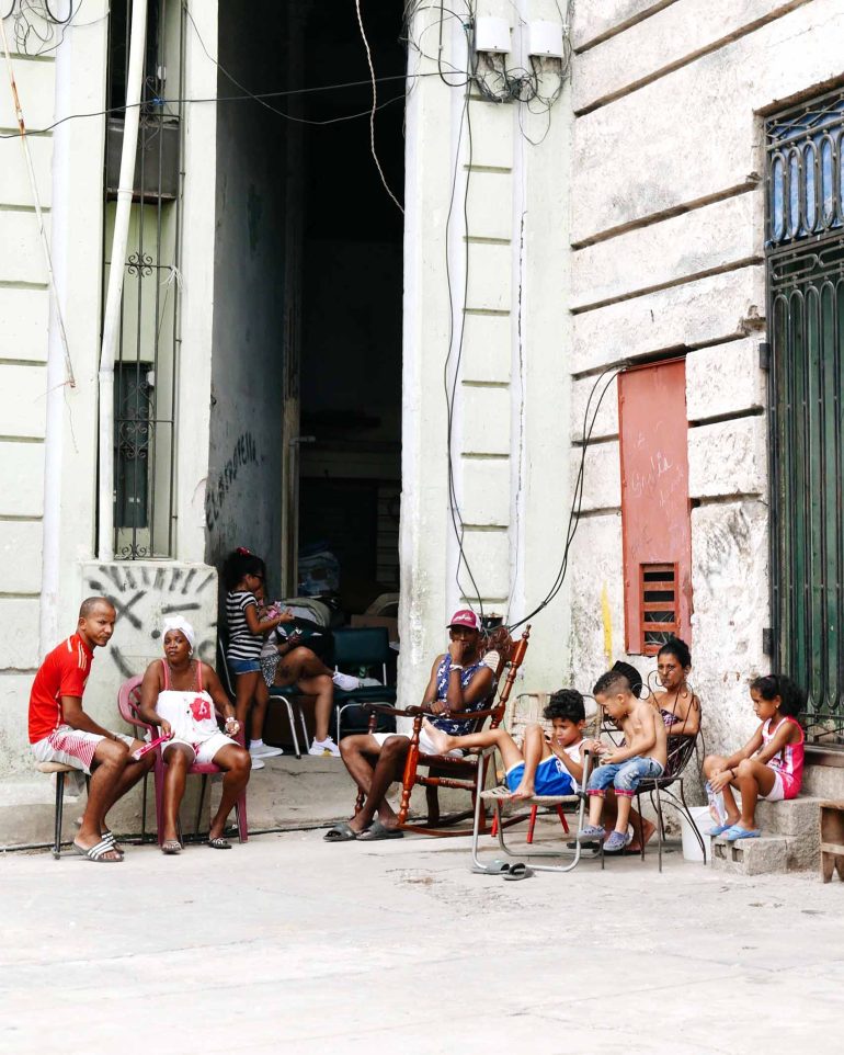 Locals sitting in the streets of Cuba