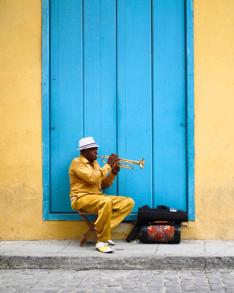 A local man plays the trumpet in Cuba