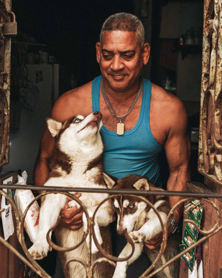 A local man holding his dogs in Cuba