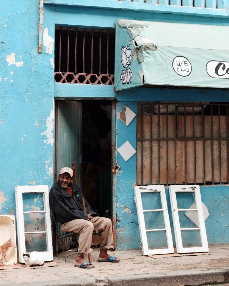 A man sits outside his house in Havana, Cuba