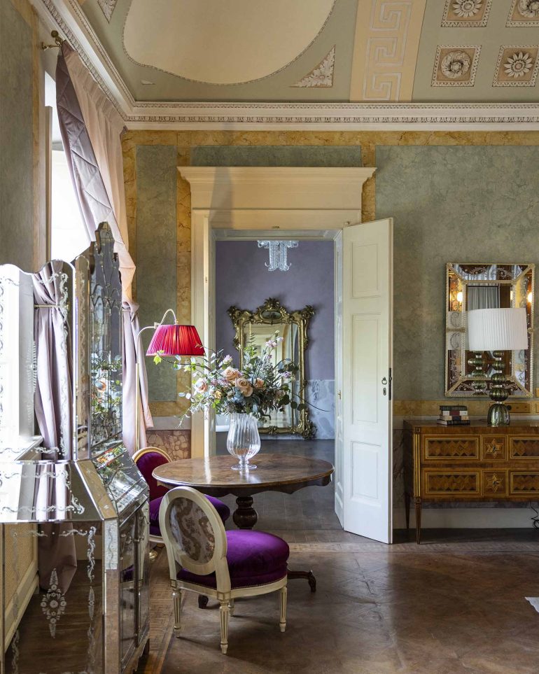 A vase of flowers greets visitors in a room at Passalacqua, Lake Como, Italy