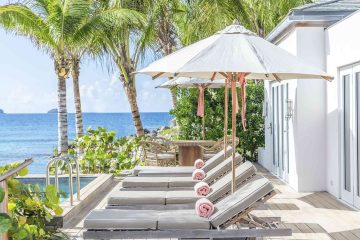 Poolside loungers with views over the Caribbean Sea at the Cheval Blanc St-Barth, Isle de France, St. Barts