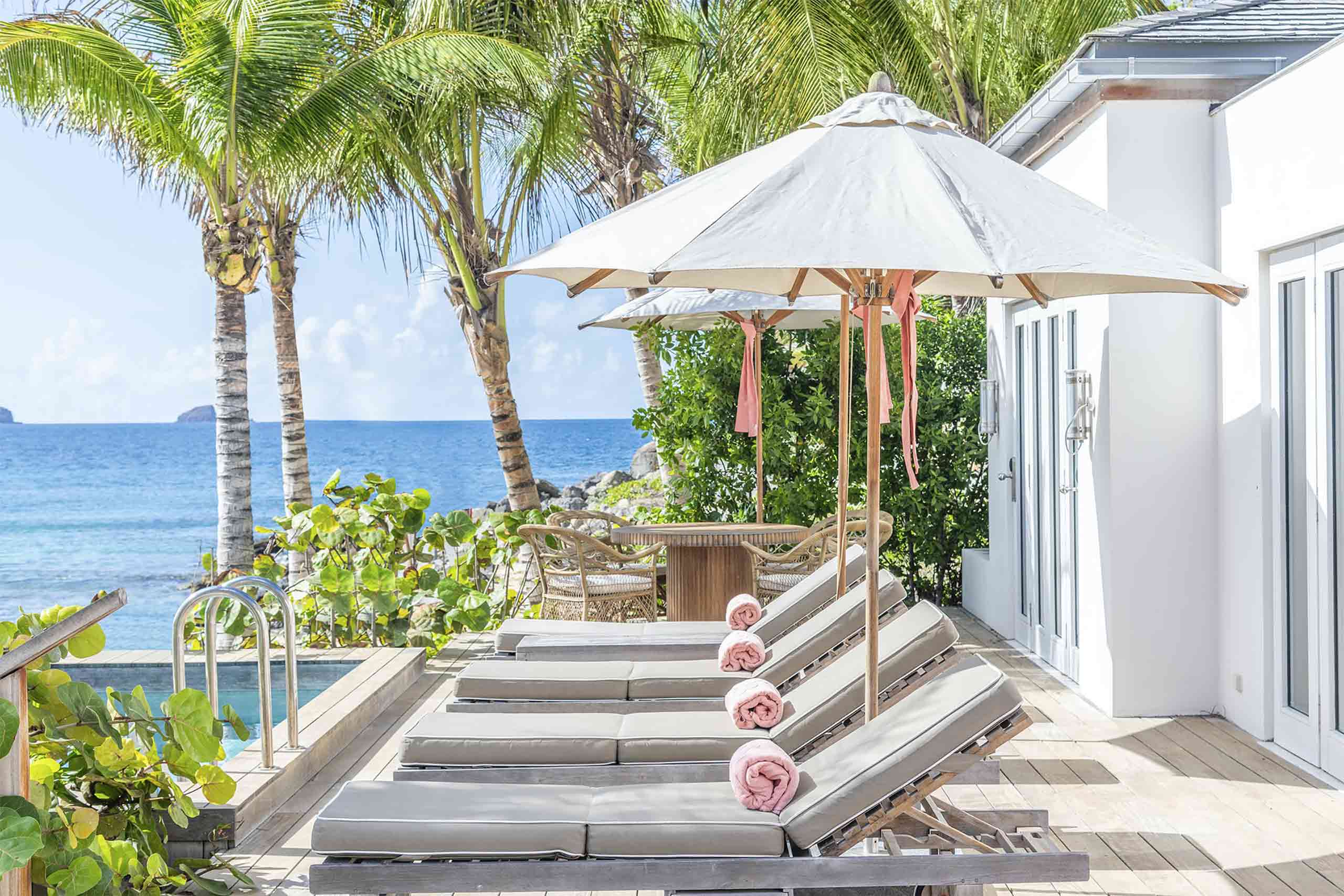 Poolside loungers with views over the Caribbean Sea at the Cheval Blanc St-Barth, Isle de France, St. Barts