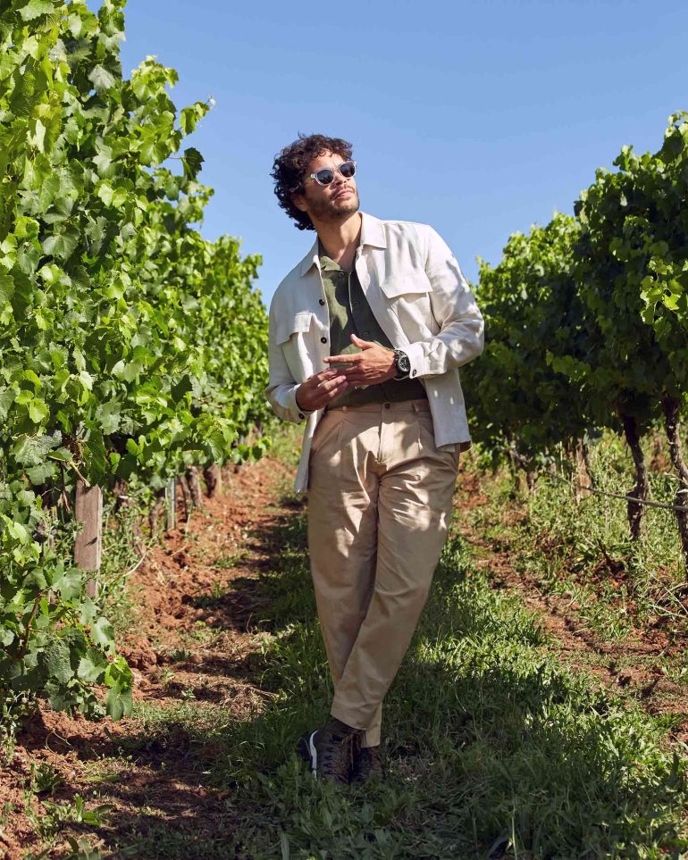 Model Nathan McGuire poses between vines, South Australia menswear editorial, Australia