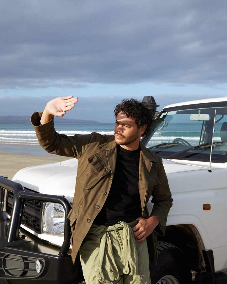 Model Nathan McGuire shields himself from the sun, South Australia menswear editorial, Australia