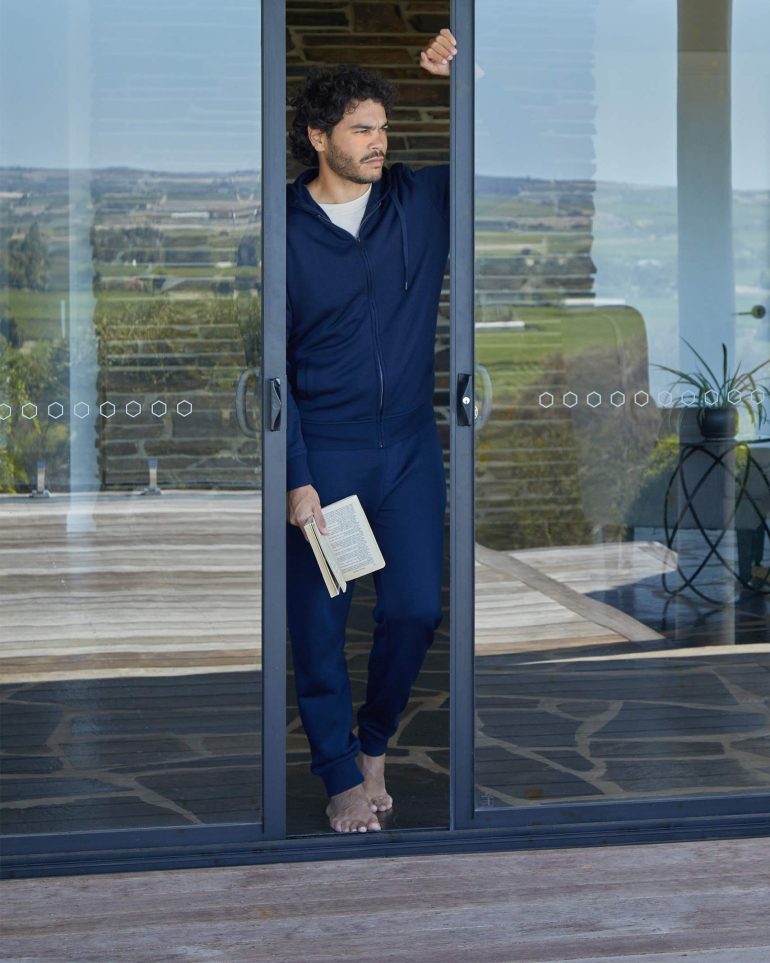Model Nathan McGuire poses in a glass door, South Australia menswear editorial, Australia