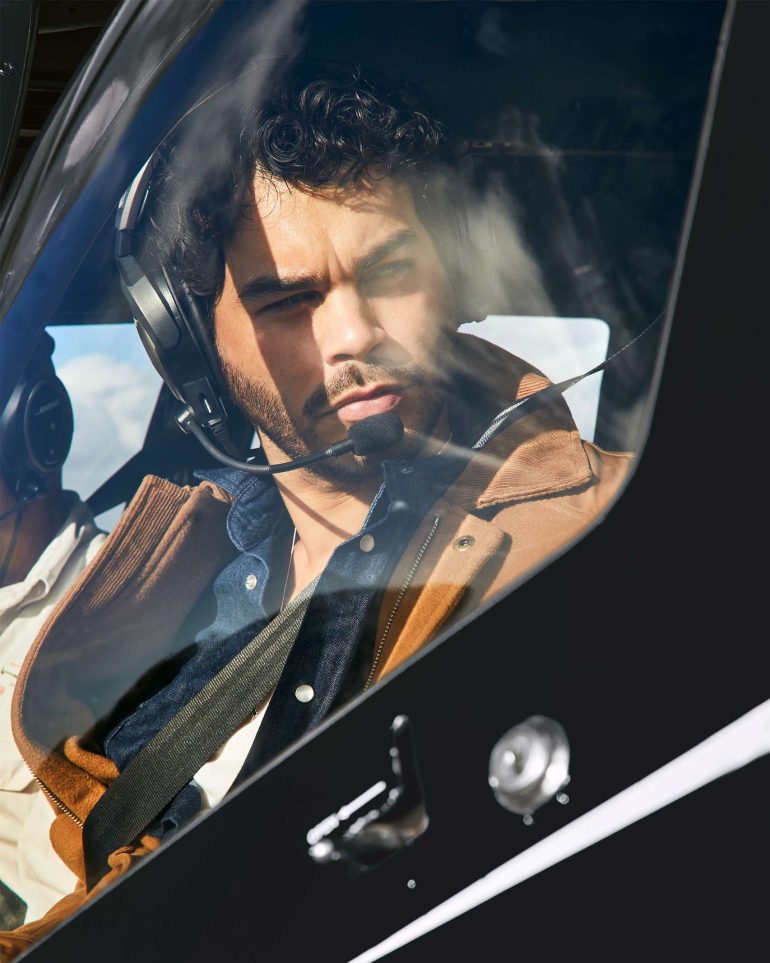 Model Nathan McGuire looks out from a helicopter, South Australia menswear editorial, Australia