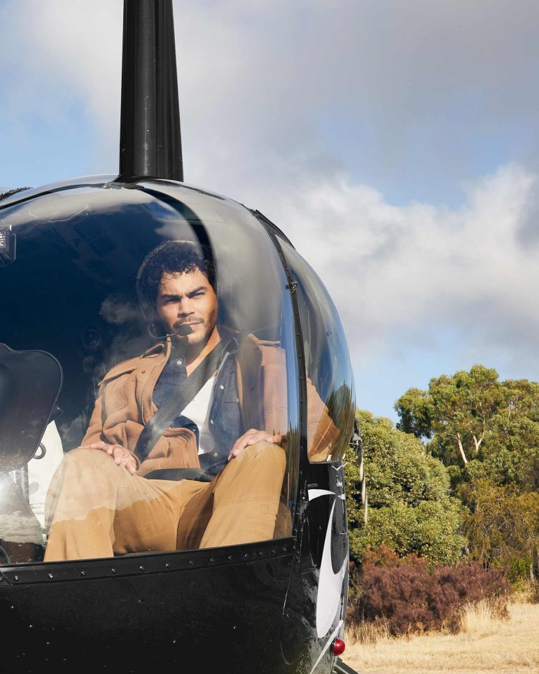 Model Nathan McGuire sits in a helicopter, South Australia menswear editorial, Australia