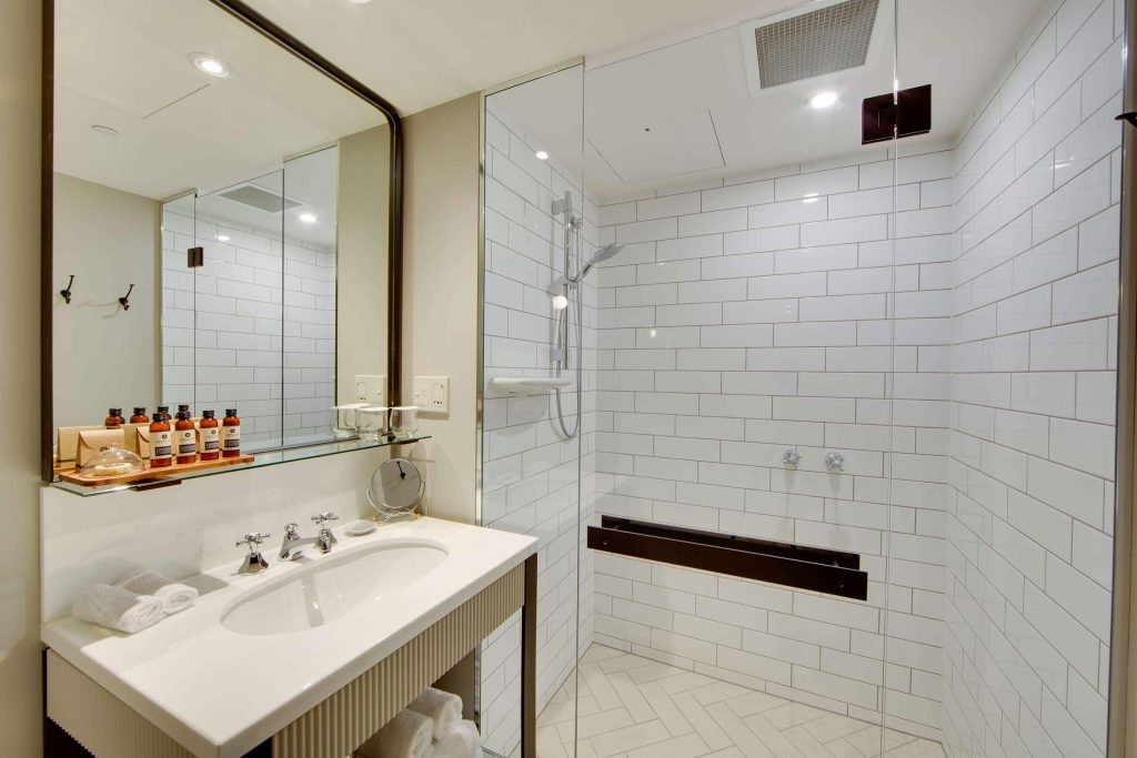 A tiled white bathroom at Mayfair Hotel, Adelaide, South Australia