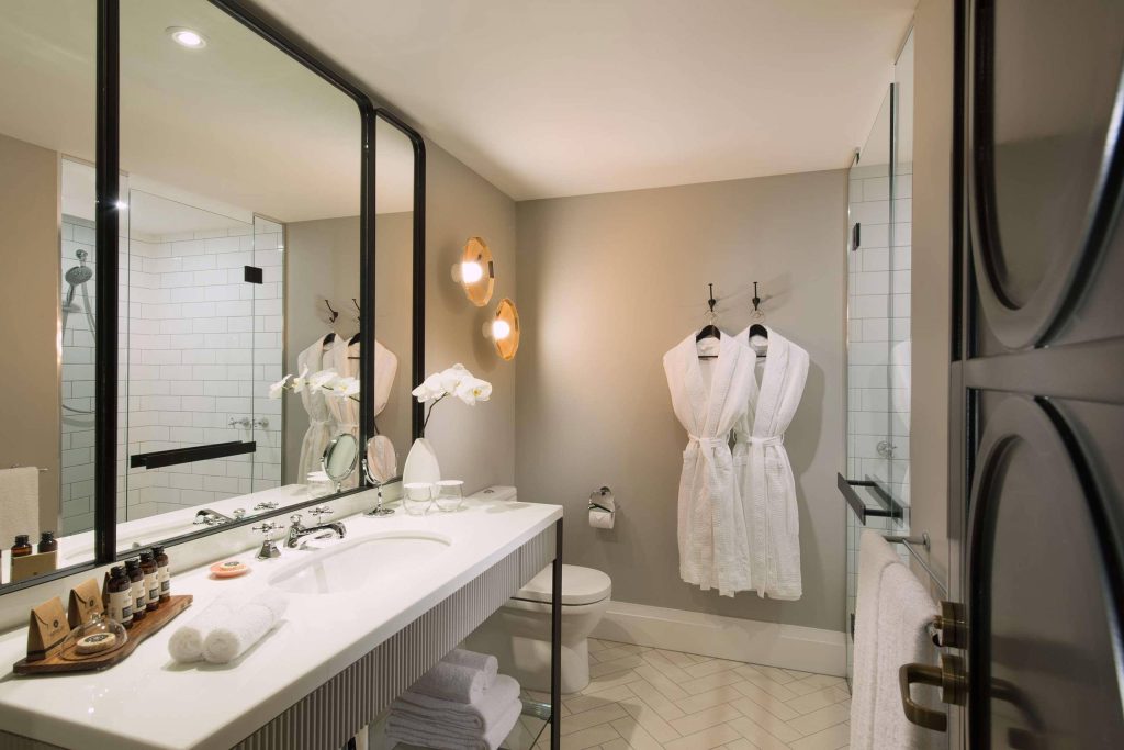 Bathroom with two white bathrobes hanging at Mayfair Hotel, Adelaide, South Australia