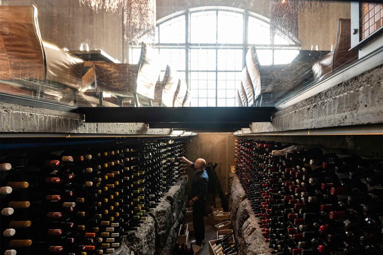 A wine cellar beneath a glass walkway at Niehku Mountain Villa, Riksgränsen, Sweden