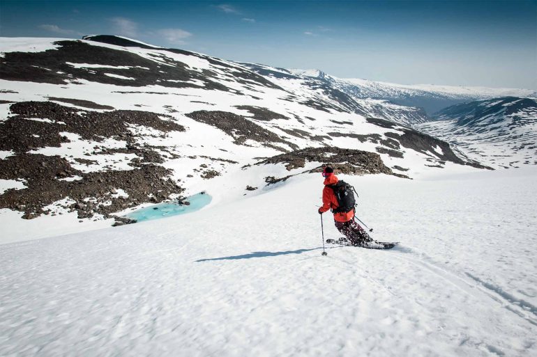 A skier enjoys a sunny day on the slopes in Swedish Lapland, Sweden