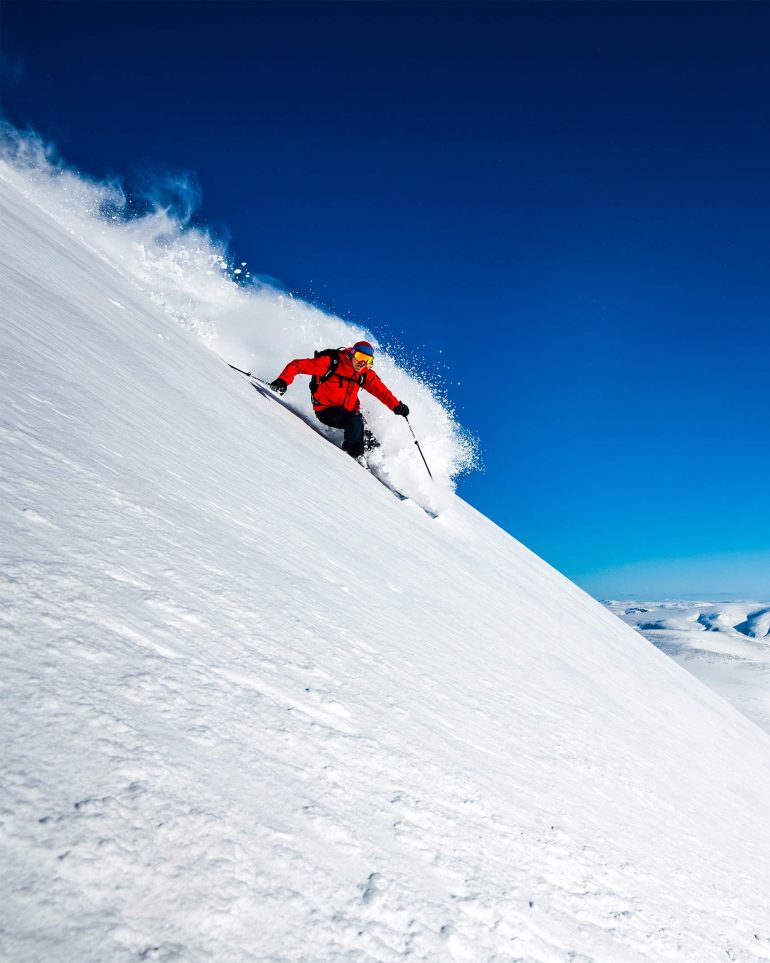 A skier goes down a mountain in Swedish Lapland, Sweden